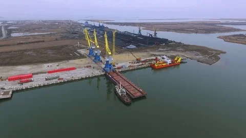 Loading cranes on a barge, Temryuk Commercial Sea Port, Russia, aerial view Stock Footage 122697272