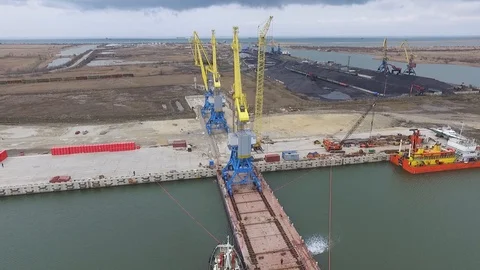 Loading cranes on a barge, Temryuk Commercial Sea Port, Russia, aerial view Stock Footage 122697912