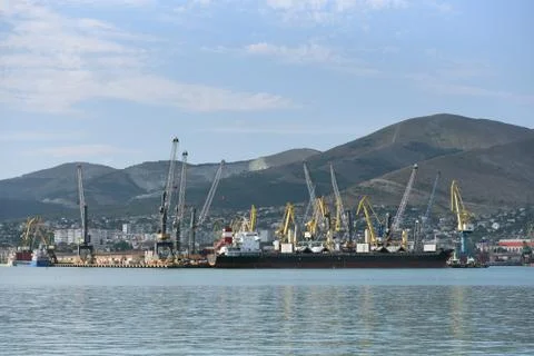 Loading cranes at the seaport unload or load a cargo ship. Cargo ship for bul Stock Photos
