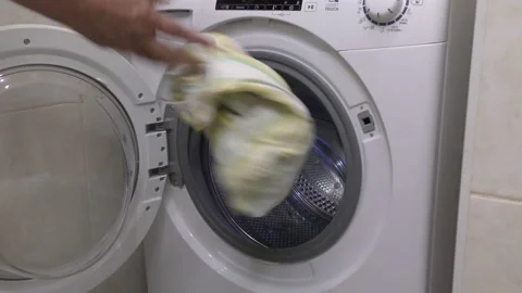 Loading dirty laundry into the washing machine. Stock Footage 132730902