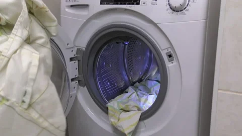 Loading dirty laundry into the washing machine. Stock Footage 132730978