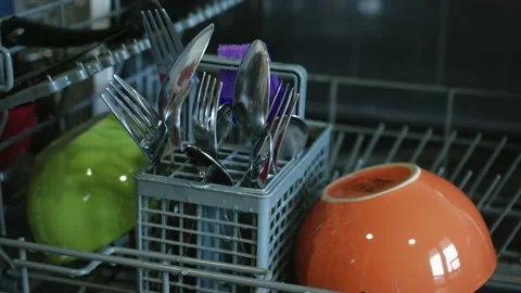 Loading dirty plates, crockery and glass into the dishwasher. Puts dirty dishes Video stock 239638206