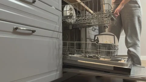 Loading Dirty Plates Into Dishwasher Preparing For Washing Kitchen Routine Video stock 336442207