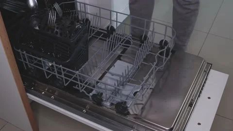 Loading dishes into the dishwasher Stock Footage 138140142