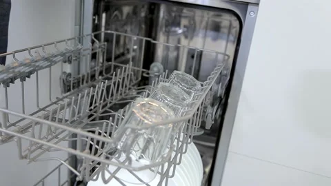 Loading dishes, glasses, wine glasses into the dishwasher Stock Footage 167797249