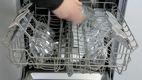 Loading dishes, glasses, wine glasses into the dishwasher Stock Footage 167797299