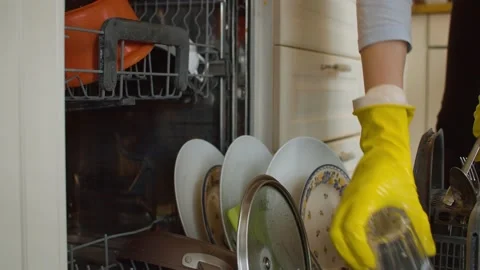 Loading dishwasher and closing it Stock Footage 131074961