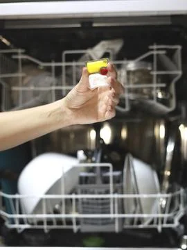 Loading a Dishwasher With a Detergent Pod Stock Photos