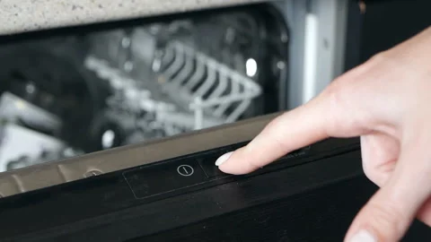 Loading the dishwasher. Washing dishes in the kitchen, chores. Household duties Stock Footage 128323483