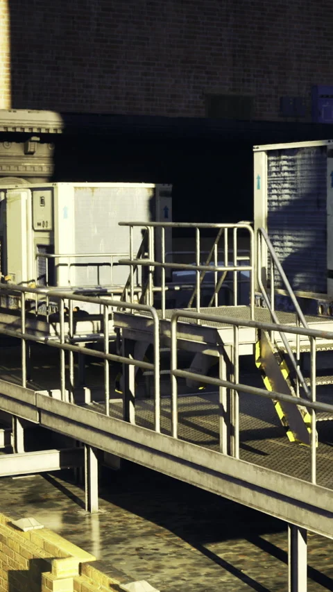 Loading dock area with metal ramps and refrigerated containers in the afternoon Vídeos de archivo 342455306
