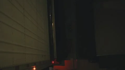 Loading dock traffic light signaling to truck driver at night Video stock 346006706