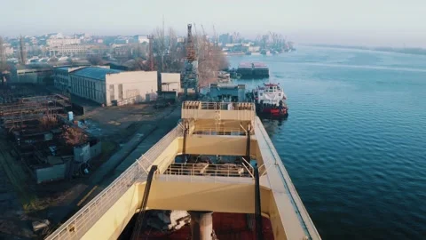 Loading of a dry cargo ship by wheat cranes in city port Varna on sunset import Stock Footage 156514519