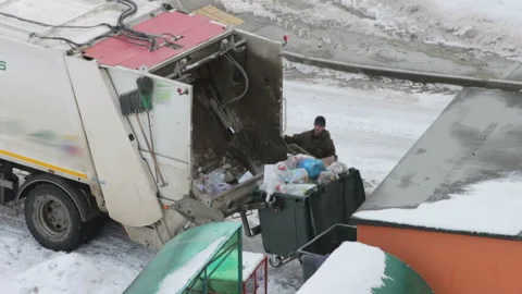 Loading garbage into a garbage truck Stock Footage 126707237