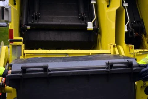 Loading garbage in the garbage truck. Garbage removal. Stock Photos