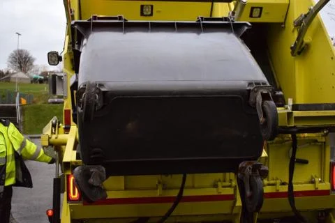 Loading garbage in the garbage truck. Garbage removal. Stock Photos
