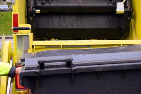 Loading garbage in the garbage truck. Garbage removal. Stock Photos