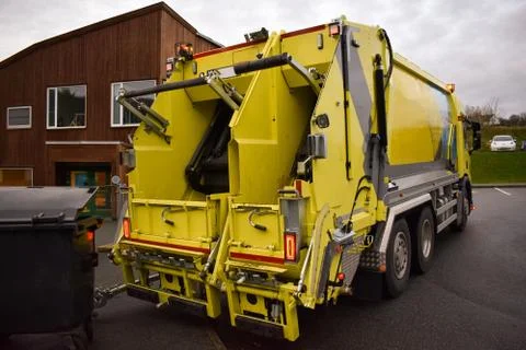 Loading garbage in the garbage truck. Garbage removal. Stock Photos