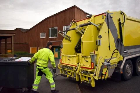 Loading garbage in the garbage truck. Garbage removal. Stock Photos