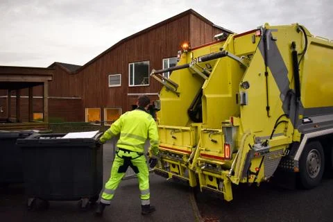 Loading garbage in the garbage truck. Garbage removal. Stock Photos