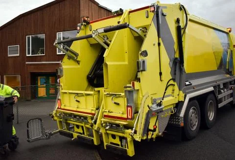 Loading garbage in the garbage truck. Garbage removal. Stock Photos