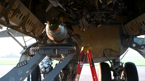 Loading of GBU-38 missiles onto a B-52 Stratofortress with a bomb loader Stock Footage 293060577