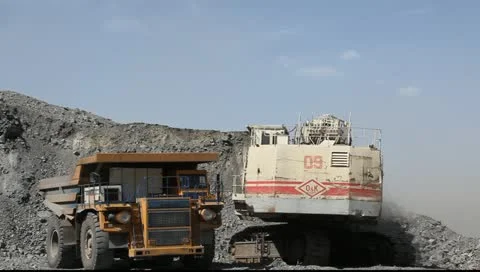 Loading the gold ore into heavy dump truck at the opencast mining Stock Footage 11056077