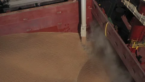 Loading grain onto a cargo ship for sea transport using a conveyor loader Stock Footage 158664957