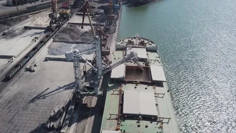 Loading grain onto a cargo ship for transportation by sea by a conveyor belt mac Stock Footage 155795250