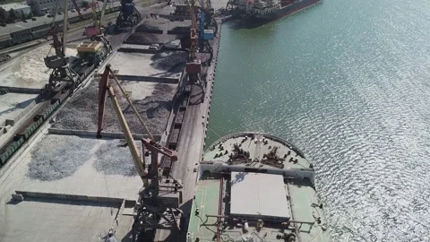 Loading grain onto a cargo ship for transportation by sea by a conveyor belt mac Stock Footage 155797793