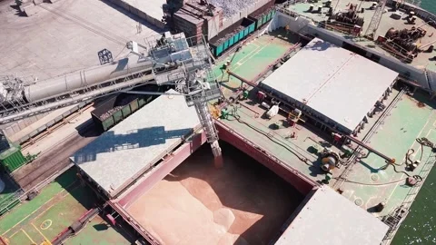 Loading grain onto a cargo ship for transportation by sea by a conveyor belt mac Stock Footage 155801123