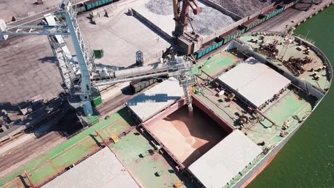 Loading grain onto a cargo ship for transportation by sea by a conveyor belt mac Stock Footage 155801208