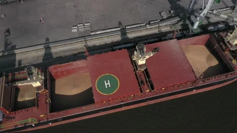 Loading grain onto a cargo ship for transportation by sea by a conveyor belt Stock Footage 157636446