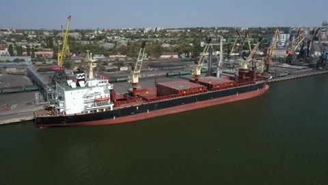 Loading grain onto a cargo ship for transportation by sea by a conveyor belt Stock Footage 157636488