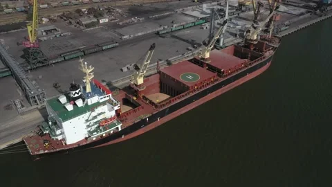 Loading grain onto a cargo ship for transportation by sea by a conveyor belt Stock Footage 157636522