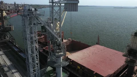 Loading grain onto a cargo ship for transportation by sea by a conveyor belt Stock Footage 157636983