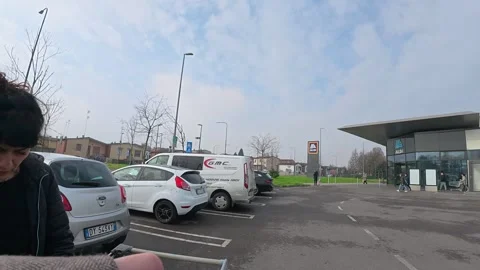 Loading groceries into car trunk at discount store parking lot in Italy Stock-Footage 332122656