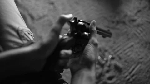 Loading gun by campfire old western wild west cowboy outlaw cowgirls army45 r Video stock 101357665