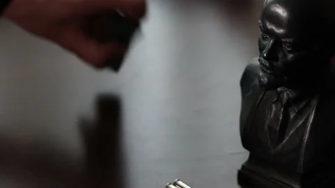 Loading Gun with Lenin Trinket. Russian Man Goes to War Stock Footage 219634109