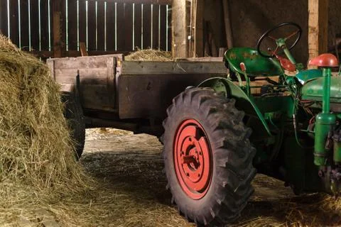 Loading hay in a barn on a tractor Stock-Fotos