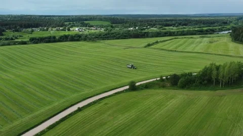 Loading hay with a combine into a tractor trailer Stock Footage 218345821