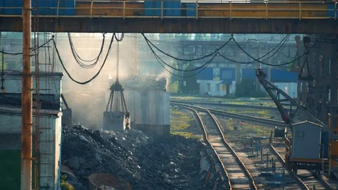 Loading iron ore in container by bucket on metallurgy heavy industry outdoor Stock Footage 108656648