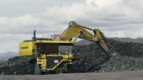 Loading a large mining truck with coal at a coal mine. Stock Footage 219857213