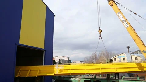 Loading of a large-sized iron beam on a railway car by crane Stock Footage 146369938