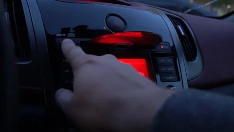 Loading a laser CD into the car stereo. Stock Footage 89258274