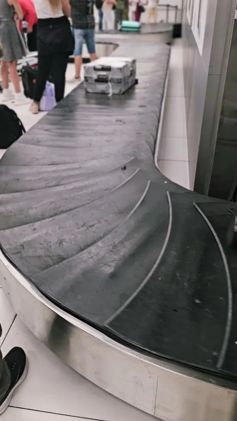 Loading luggage moving on baggage conveyor belt during post flight unloading Stock Footage 314214730