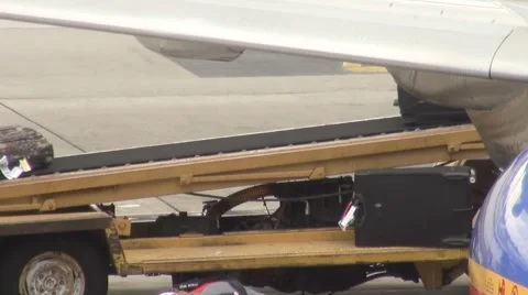 Loading luggage onto plane Stock Footage 1239987