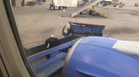 Loading luggage onto plane Stock Footage 1240092