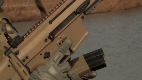 Loading magazine in to a gun Video stock 76940232