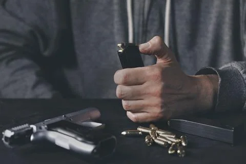 Loading magezine of 9 mm compact handgun with munition Stock Photos