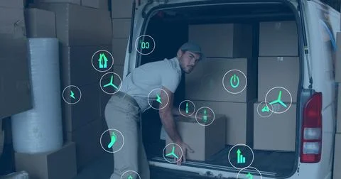 Loading man in polo, khakis lifting boxes into white van in warehouse with Stock Photos